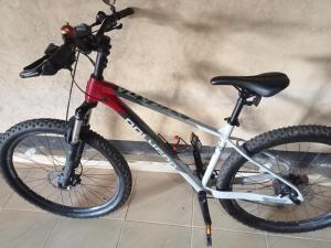 a bike is parked next to a wall at Zinzi's All-Inclusive Homestay in Sangyang