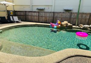 a small swimming pool with a toy and frisbee at Exchange Hotel Backpacker Resort in Mossman