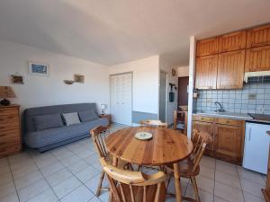 une cuisine et une salle à manger avec une table en bois dans l'établissement Port-Vendres: Studio cabine avec terrasse, à 2 pas du port - FR-1-309-256, à Port-Vendres