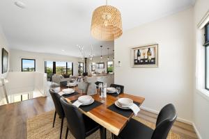a dining room and living room with a table and chairs at The Sandbar Stay - Wi-Fi, BBQ, Parking in Middleton