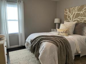 a bedroom with a bed with a blanket on it at 2 Whole Apartments Combined, Big House for Large groups 4 beds, 1 futon , Pet Friendly in South Euclid
