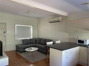 a living room with a couch and a table at Units on Robertson in Mudgee