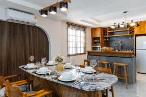 a kitchen and dining room with a large table and chairs at Villa Abigail Chiang Mai in Chiang Mai +84 photos