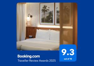 a hotel room with a bed with white sheets at Leafy Home Canggu in Canggu