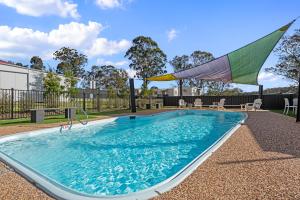 a swimming pool with a flag on top of it at Crows Nest Tourist Park in Crows Nest