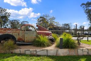 an old rusted truck sitting in a park at Crows Nest Tourist Park in Crows Nest