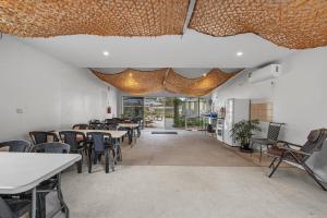 a dining room with tables and chairs and lights at Crows Nest Tourist Park in Crows Nest