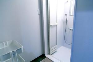 a bathroom with a shower and a sink at Hostel JAQ takamatsu in Takamatsu