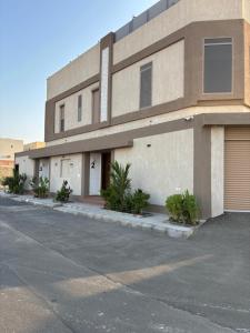 ein Gebäude mit einem Parkplatz davor in der Unterkunft شاطئ اللؤلؤ وحده مفروشه 2 in Bucht Obhor