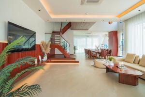 a living room with a couch and a table at The IBIZA in Ha Long