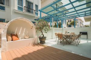 an outdoor patio with a table and chairs at The IBIZA in Ha Long