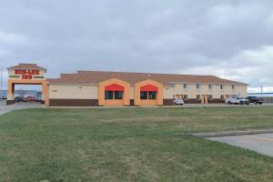 a building with a parking lot in front of it at Eco-Lux Inn Norfolk in Norfolk