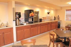 a kitchen with wooden cabinets and a counter top at Eco-Lux Inn Norfolk in Norfolk