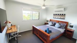 a bedroom with a bed and a desk and a window at Retreat Haven--The Perfect Master Bedroom Getaway in Dakabin +21 photos