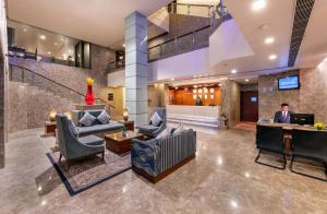 a man is standing in the lobby of a hotel at Lords Plaza Jaipur in Jaipur