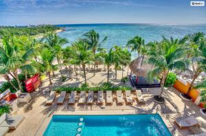 an aerial view of a resort with a swimming pool and the beach at Tankah Bay 56 in Balcheil