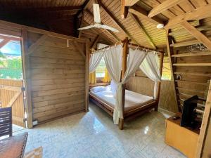 a bedroom with a bed in a wooden room at Lodge Indigo in Le Gosier +31 photos