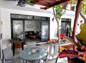 a living room with a table and chairs at Villa Tucanes in Tulum