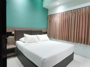 מיטה או מיטות בחדר ב-Sun In Pangandaran Hotel