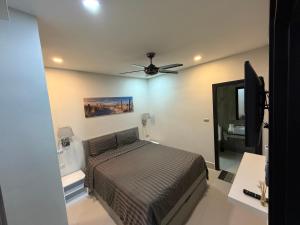 a bedroom with a bed and a ceiling fan at Orchid Pool Villas - Koh Chang in Ko Chang +5 photos