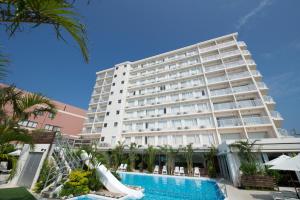 a large hotel with a swimming pool in front of it at Hotel Gran View Garden Okinawa in Tomigusuku