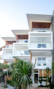 an exterior view of a white building with palm trees at Jony's Boutique Hotel in Boracay