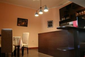 a bar with chairs and a table in a room at Vila Prica in Niška Banja