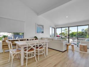 a living room with a table and a couch at Blue at Nelson Bay in Nelson Bay