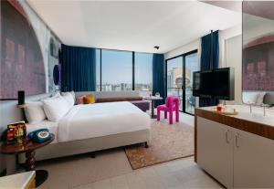 a hotel room with a bed and a television at Hotel Indigo Sydney Potts Point by IHG in Sydney