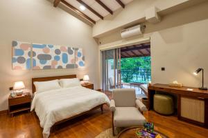a bedroom with a bed and a desk and a chair at Arambhaya Boutique Hotel in Kandy +90 photos