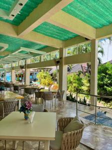 a restaurant with tables and chairs and windows at Casa Pilar Beach Resort in Boracay