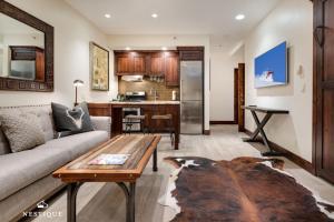 a living room with a couch and a table at LMV A-107 in Park City