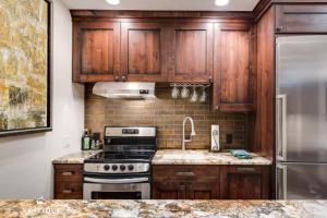 a kitchen with wooden cabinets and a stove and a sink at LMV A-107 in Park City