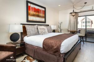 a bedroom with a large bed and a living room at LMV A-107 in Park City