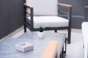 a table with a box on top of it with a chair at Santa Rosa Apartments in Kalamata