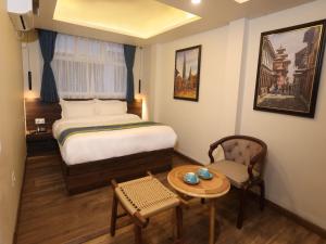 Letto o letti in una camera di Harsha Boutique Hotel