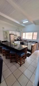 a large kitchen with a large table and chairs at Villa Del Sol Unit 8 in Margate