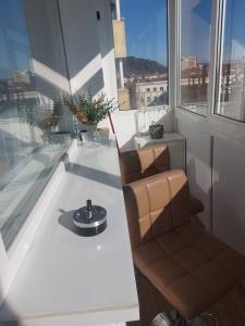 a chair sitting on a table in a room with a window at Urban Luxury Escape in Piatra Neamţ