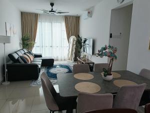 a living room with a table and a couch at Raycation Homestay in Johor Bahru