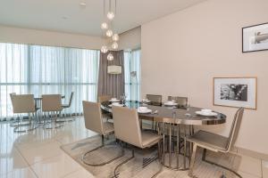a dining room with a table and chairs at 2BR Luxurious Damac Paramount Burj Khalifa view Pool, Gym, Bar & Sauna in Dubai