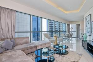 a living room with a couch and glass tables at 2BR Luxurious Damac Paramount Burj Khalifa view Pool, Gym, Bar & Sauna in Dubai