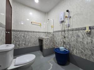 a bathroom with a toilet and a shower at Hotel O Villa Impiana in Bachok +48 photos