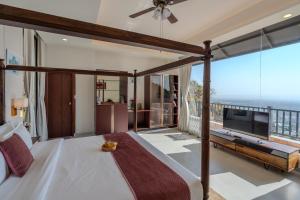 a bedroom with a bed and a large window at SaffronStays Glasscape in Dehradun