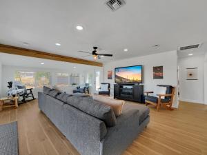 a living room with a couch and a flat screen tv at Boulder Apache Junction in Apache Junction