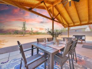 a wooden table and chairs under a pavilion at Boulder Apache Junction in Apache Junction