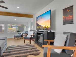 a living room with a couch and a tv at Boulder Apache Junction in Apache Junction