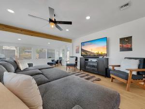 a living room with a couch and a flat screen tv at Boulder Apache Junction in Apache Junction