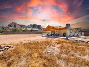 a house in the middle of a field with a mountain at Boulder Apache Junction in Apache Junction