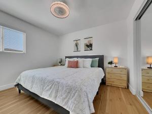 a white bedroom with a bed and two night stands at Boulder Apache Junction in Apache Junction