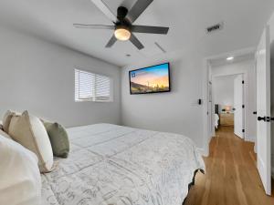 a bedroom with a bed with a ceiling fan at Boulder Apache Junction in Apache Junction